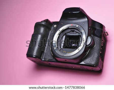 Digital Camera isolated on pink background. Photography equipment