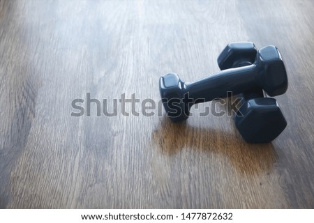 blue dumbbells on wooden background, healthy lifestyle, body slimming concept, cares about body, empty place for text.