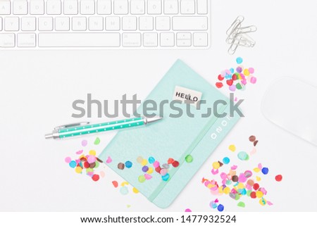 Desk with colorful confetti, keyboard and mouse, calendar 2020 and a ballpoint pen