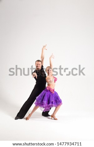 ballroom dancers, hand forward, in purple dress