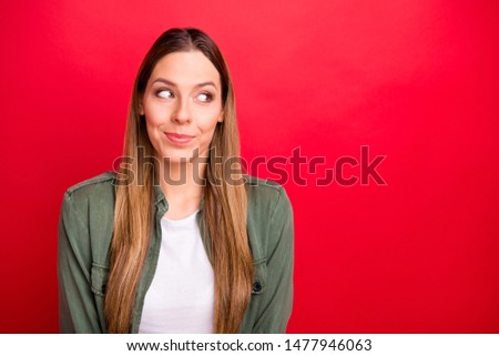 Photo of attractive smiling cute girl making up some prank while isolated with red background