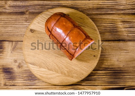 Cutting board with sausage on rustic wooden table. Top view