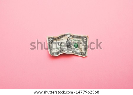 Crumpled two US dollar bill isolated on pink background Royalty-Free Stock Photo #1477962368