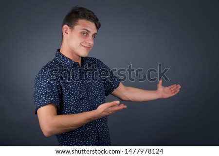Young handsome caucasian businessman over isolated background Inviting to enter smiling natural with open hands. Welcome sign.
