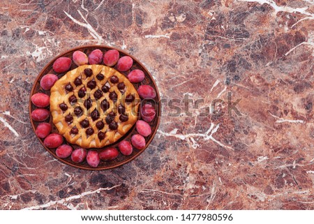 Plum and cherry tart, copy space, selective focus. Plum cake on a light background, delicious seasonal dessert