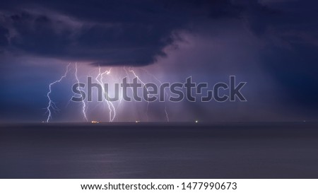 beautiful lightning in the sea, thunderclouds with lightning, lightning discharges