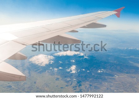 Wing of an airplane. Traveling concept. Aircraft wing on the clouds.