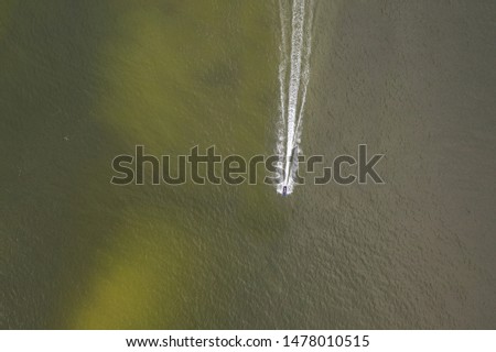 Aerial drone photography of a tourist ridding a scooter, Baltic sea attractions. 