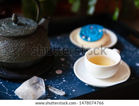 Green tea on a starry tray with galaxy themed cookies.