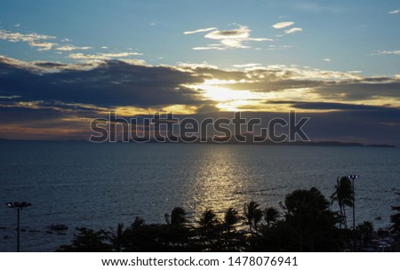 The sun light that shines through the clouds above the sea Natural, beautiful