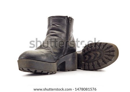 A studio photo of a pair of black boots
