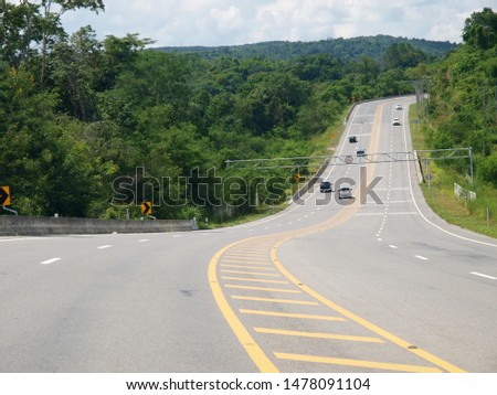 beautiful scene of new constructed highway street road between towns in northern of THAILAND surrounding with tropical plants trees forest and hills with green nature surroundings.