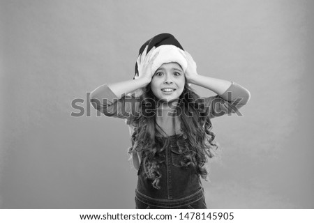Little girl child in santa hat. Christmas shopping. Present for Xmas. Childhood. New year party. Santa claus kid. Happy winter holidays. Small scared girl. Santa, please stop here.