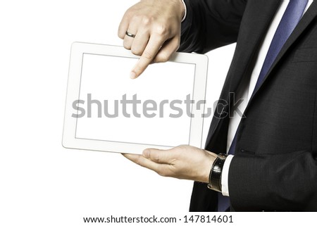Business man in black suit shows something on his tablet computer, isolated on white background