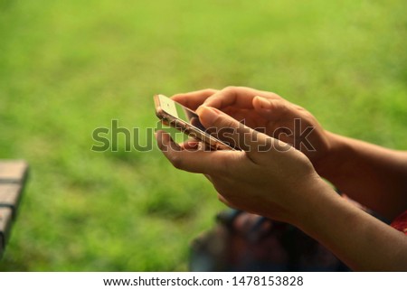 Close up photo of 
woman 's hands is using smart phone at outdoor. Have space for text.