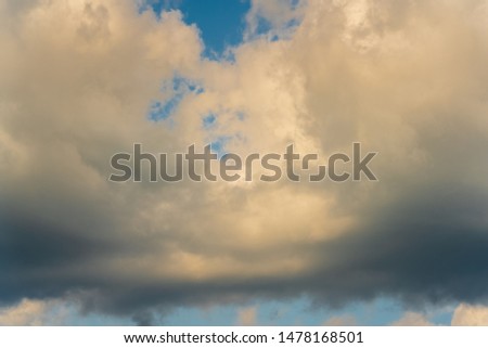 Beautiful summer natural meteorology background: stunning cloudscape, dramatic clouds floating across blue sky to weather change before rain. Atmospheric dispersion, motion blur clouds and soft focus.