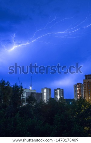 General plan of lightning over the city in the night sky blue