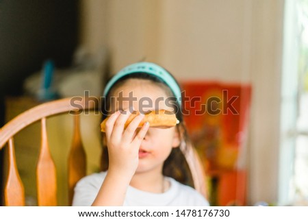 Portrait of Little asian girl child hand cover and close her mouth and face with no appetite in front of the meal.Concept of loss of appetite.