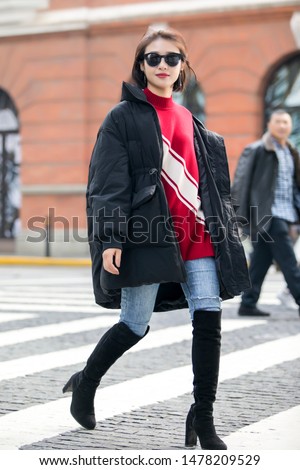 Asian girl in black coat on the streets of Shanghai