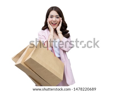 Happy Asian woman holding shopping bags and enjoying excited about shopping sale isolated on white background