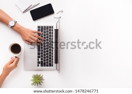 Top view of businesswoman typing on laptop on workplace and drinking coffee, copy space Royalty-Free Stock Photo #1478246771
