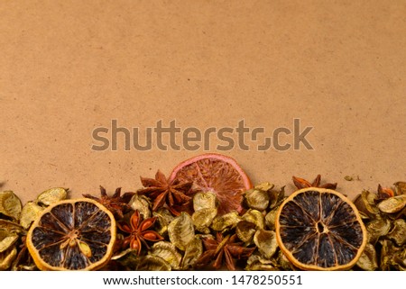 Autumn background with golden leaves, dried fruts, cinnamon and anis. Space for text or design. 