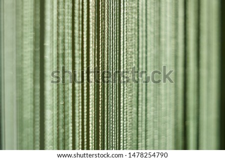 Abstract green background of thin nylon threads. Close-up. Small DOF