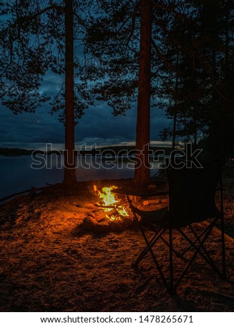 Wild camping by the lake, fireplace in the evening