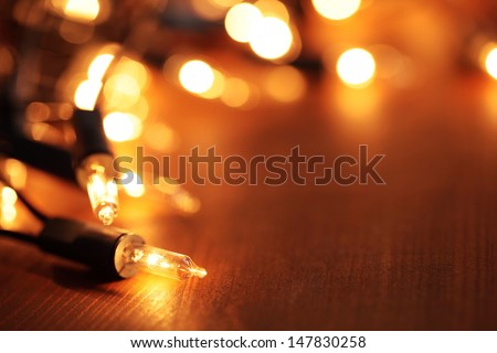 Christmas lights on dark wooden background