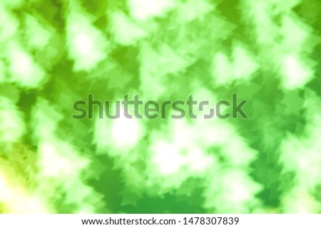 Blurred green background with bokeh in the shape of fir tree.Texture with soft focus