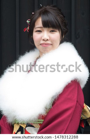 Japanese girl posing for the pictures of the Coming of Age Day. In Japan, people celebrate their 20s of a year as becoming adults wearing Japanese tradition dress. 