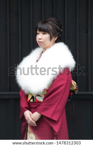 Japanese girl posing for the pictures of the Coming of Age Day. In Japan, people celebrate their 20s of a year as becoming adults wearing Japanese tradition dress. 
