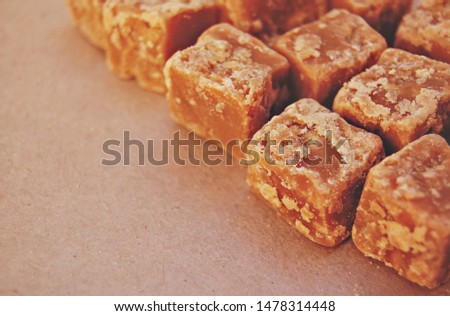Macro photo of many  brown salted caramel toffee isolated at white background.  Sweet  golden Butterscotch. 