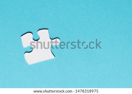 White single puzzle piece on blue background