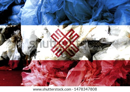 The flag Mari El is shown on the trash bag. Ecology concept with environmental pollution from household and industrial waste.