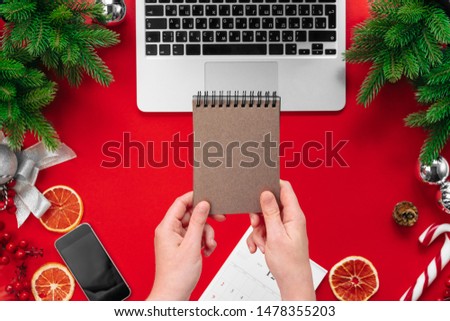 Female hand. Woman working at an office table with christmas festive decorations