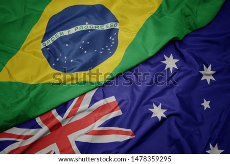 waving colorful flag of australia and national flag of brazil. macro