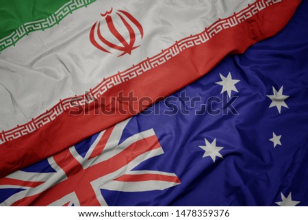 waving colorful flag of australia and national flag of iran. macro