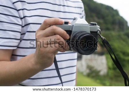 Male with vintage film camera.
