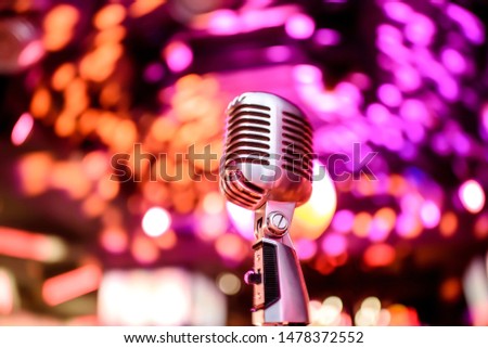 Karaoke background.Silver vintage microphone on bokeh.Close-up of retro microphone at concert.Professional microphone Royalty-Free Stock Photo #1478372552