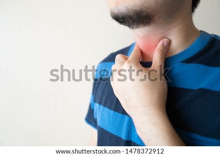 Sick man suffering from sore throat. Causes of throat pain include flu, common cold, respiratory tract infections, allergies or GERD. Health care and medical concept. Close up. Copy space. Royalty-Free Stock Photo #1478372912