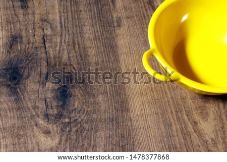 Top view empty yellow bowl on rustic wooden table