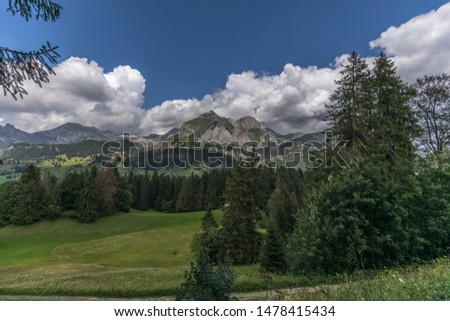 Hiking through swiss alps on a sunny day with blue sky near toggenburg, gamsalp