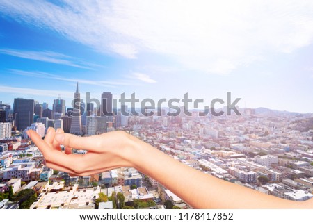 Hand holding San Francisco towers in the palm, USA