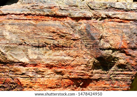 Ancient wall made of large stones of iron ore bonded by sand. Royalty-Free Stock Photo #1478424950