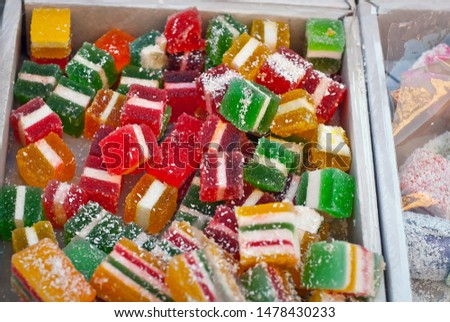 Turkish national sweets are sold at the fair. Multi-colored Asian desserts stacked on the table. Rahat lokum in bulk is sold at the festival.