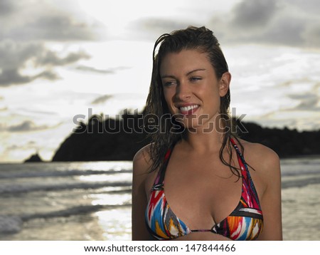 Closeup portrait of a young woman in bikini at beach