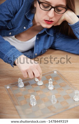 woman play chess on the floor