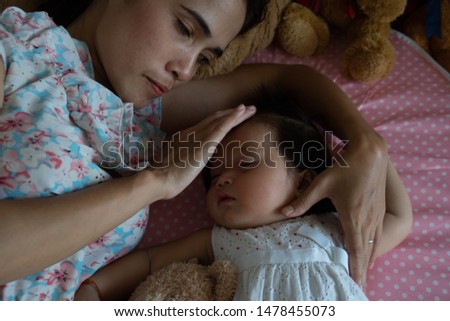 Young mom kiss baby girl 
