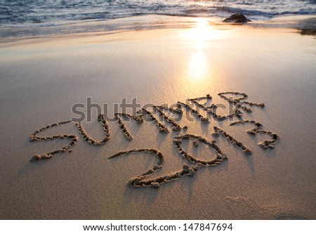 Inscription on wet sand Summer 2013 in the beach. Concept of vacation. Royalty-Free Stock Photo #147847694